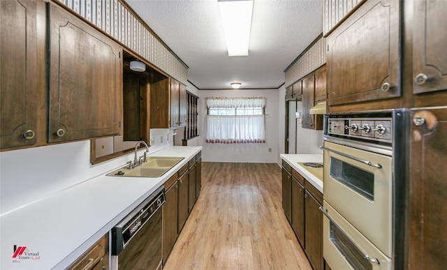 5023 Dedman Dr, Shreveport, LA 71107 - kitchen with a sink, black dishwasher, light countertops, white oven, and a textured ceiling