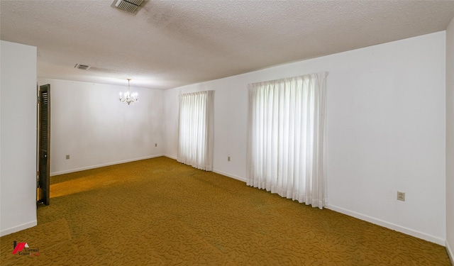 5023 Dedman Dr, Shreveport, LA 71107 - carpeted spare room with a chandelier, baseboards, and a textured ceiling