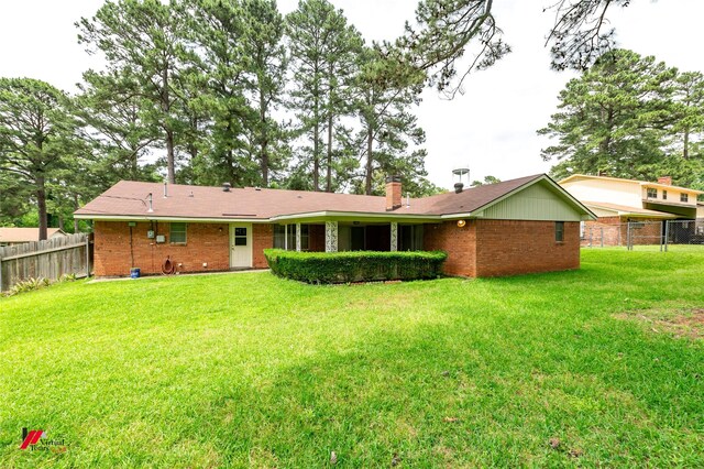 5023 Dedman Dr, Shreveport, LA 71107 - rear view of property featuring brick siding and a chimney