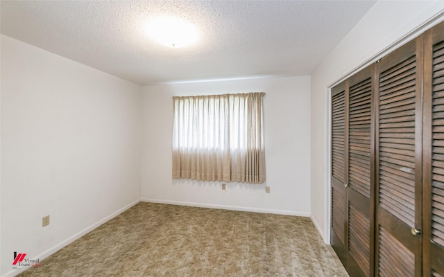 5023 Dedman Dr, Shreveport, LA 71107 - unfurnished bedroom featuring a closet, carpet floors, a textured ceiling, and baseboards