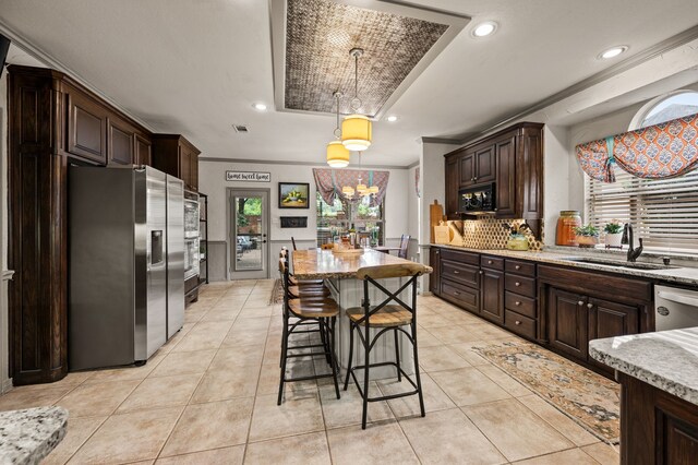4213 Fairway Crossing Dr, Fort Worth, TX 76137 - kitchen with appliances with stainless steel finishes, dark brown cabinetry, a sink, light tile patterned floors, and light stone counters