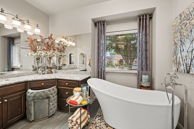 4213 Fairway Crossing Dr, Fort Worth, TX 76137 - full bathroom with wood finished floors, double vanity, and a soaking tub
