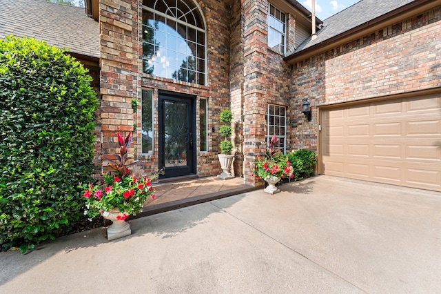 4213 Fairway Crossing Dr, Fort Worth, TX 76137 - doorway to property featuring brick siding, driveway, an attached garage, and roof with shingles