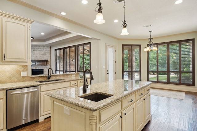 301 Harrison Cir, Van Alstyne, TX 75495 - kitchen featuring stainless steel dishwasher, cream cabinetry, a sink, ornamental molding, and recessed lighting