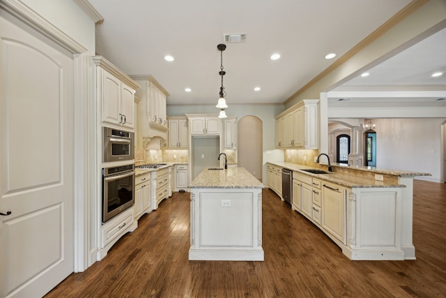 301 Harrison Cir, Van Alstyne, TX 75495 - kitchen with a sink, arched walkways, a peninsula, tasteful backsplash, and ornamental molding