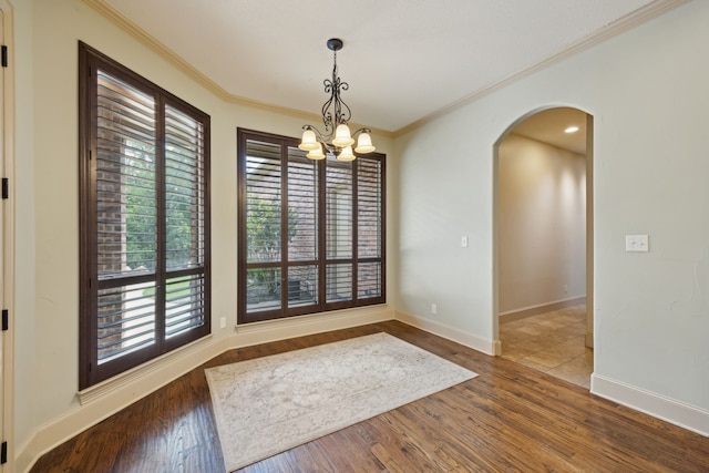 301 Harrison Cir, Van Alstyne, TX 75495 - unfurnished room featuring arched walkways, a chandelier, crown molding, wood finished floors, and baseboards