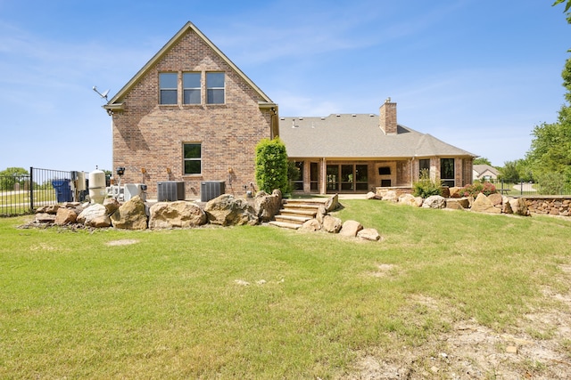 301 Harrison Cir, Van Alstyne, TX 75495 - rear view of house featuring brick siding, a chimney, and central AC unit