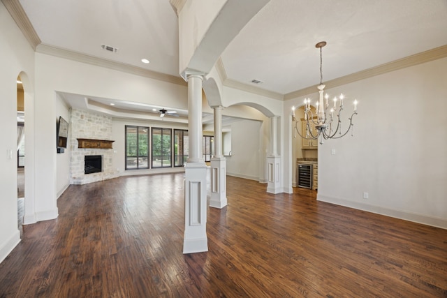 301 Harrison Cir, Van Alstyne, TX 75495 - unfurnished living room with crown molding, a fireplace, wine cooler, ornate columns, and baseboards
