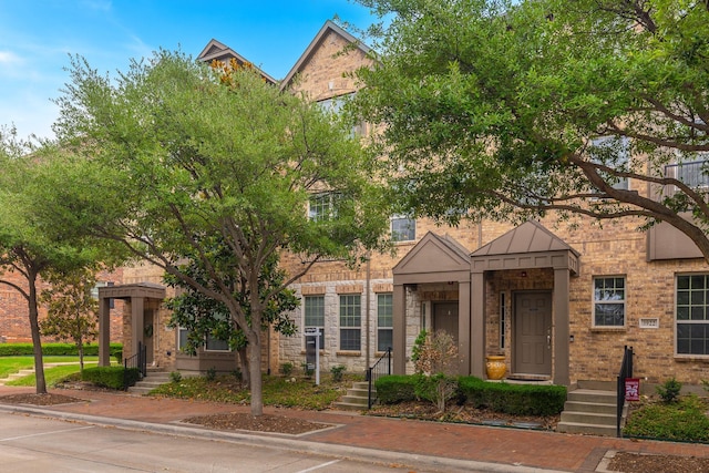 3924 Asbury Ln, Addison, TX 75001 - view of front of house featuring a standing seam roof, brick siding, and metal roof