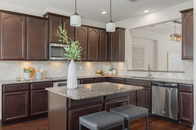 3924 Asbury Ln, Addison, TX 75001 - kitchen with appliances with stainless steel finishes, a sink, dark brown cabinetry, light stone countertops, and recessed lighting