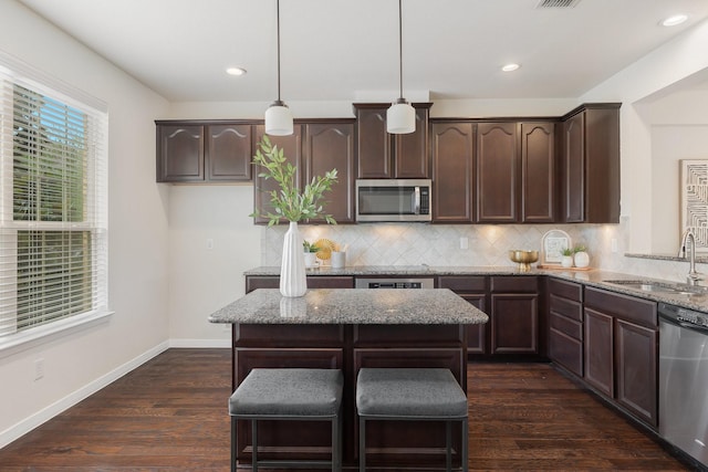 3924 Asbury Ln, Addison, TX 75001 - kitchen featuring a sink, stainless steel appliances, dark brown cabinets, light stone counters, and backsplash