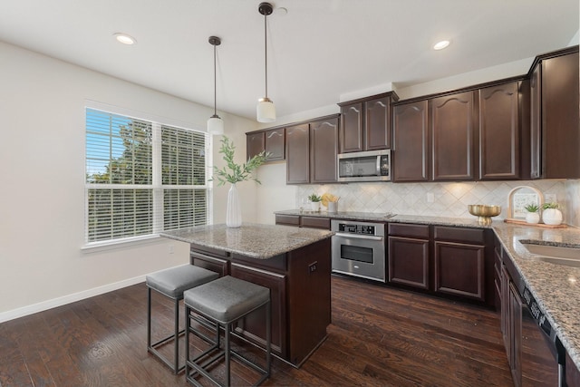3924 Asbury Ln, Addison, TX 75001 - kitchen with stainless steel appliances, dark brown cabinets, decorative backsplash, and recessed lighting