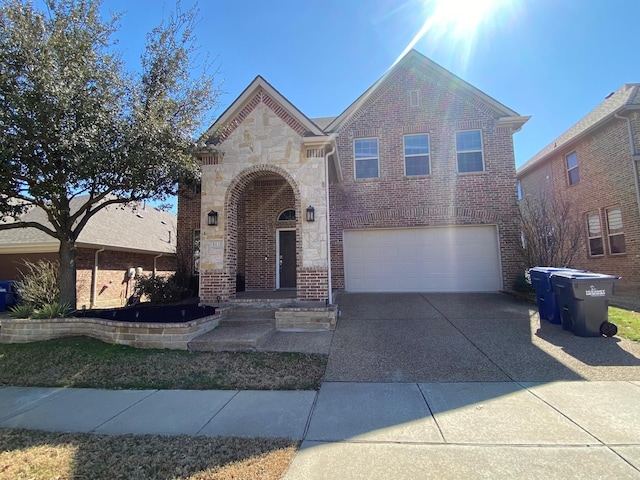 5833 N Silverton Ave, Mckinney, TX 75070 - view of front facade featuring an attached garage, stone siding, concrete driveway, and brick siding