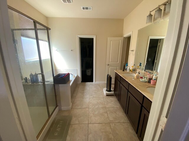 5833 N Silverton Ave, Mckinney, TX 75070 - full bath with a shower stall, tile patterned floors, a spacious closet, double vanity, and a tub