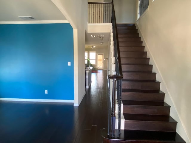 5833 N Silverton Ave, Mckinney, TX 75070 - stairway with wood finished floors, baseboards, a towering ceiling, and crown molding