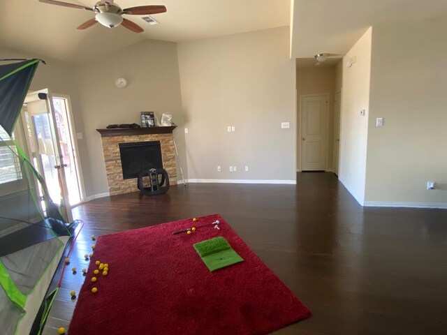 5833 N Silverton Ave, Mckinney, TX 75070 - living room with wood finished floors, a ceiling fan, a stone fireplace, lofted ceiling, and baseboards