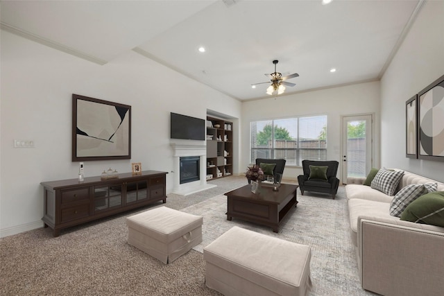 1004 Taylor Dr, Allen, TX 75013 - carpeted living room featuring crown molding, recessed lighting, ceiling fan, a glass covered fireplace, and baseboards