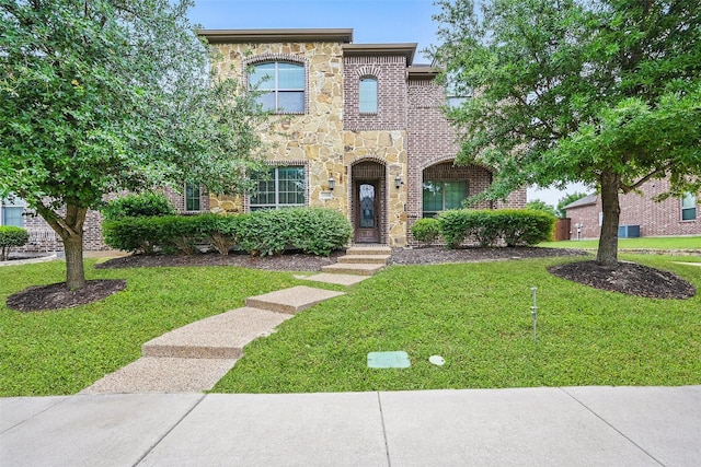1004 Taylor Dr, Allen, TX 75013 - view of front facade with stone siding, a front yard, and brick siding