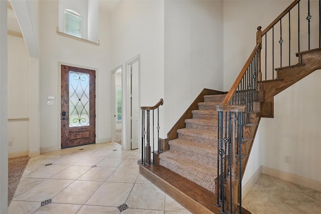 1004 Taylor Dr, Allen, TX 75013 - foyer with a towering ceiling, stairway, light tile patterned flooring, and baseboards