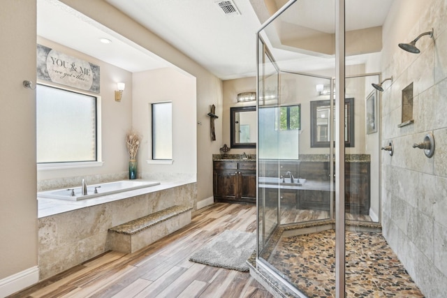 1389 County Road 3591, Paradise, TX 76073 - full bath with a shower stall, a garden tub, vanity, and wood finished floors