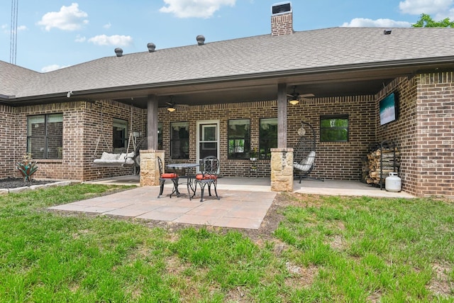 1389 County Road 3591, Paradise, TX 76073 - back of property with a ceiling fan, brick siding, and roof with shingles