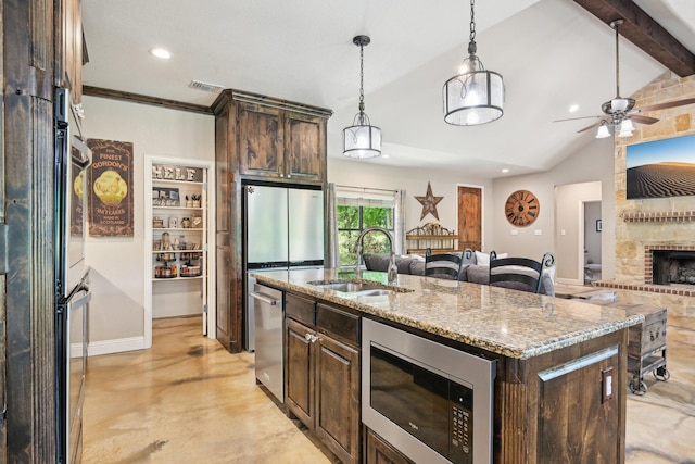 1389 County Road 3591, Paradise, TX 76073 - kitchen featuring appliances with stainless steel finishes, a sink, open floor plan, recessed lighting, and dark brown cabinetry