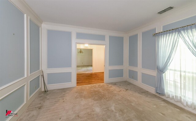 9855 Holamy Ln, Shreveport, LA 71106 - spare room featuring a decorative wall, crown molding, and carpet floors