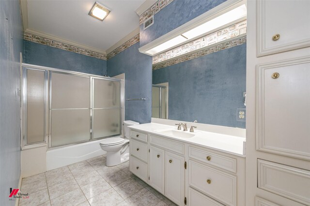 9855 Holamy Ln, Shreveport, LA 71106 - bathroom featuring tile patterned floors, toilet, vanity, and combined bath / shower with glass door