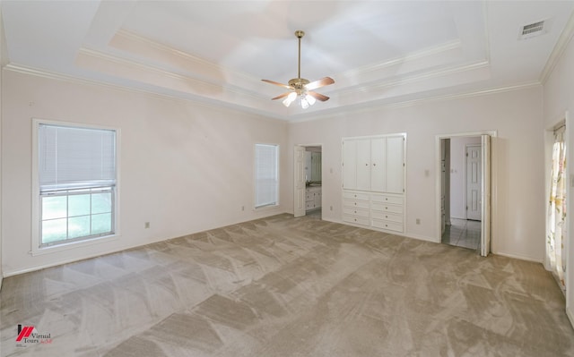 9855 Holamy Ln, Shreveport, LA 71106 - unfurnished bedroom with a tray ceiling, ornamental molding, light colored carpet, a ceiling fan, and baseboards