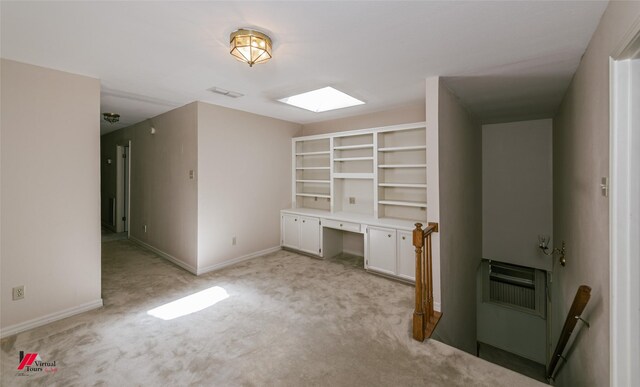 9855 Holamy Ln, Shreveport, LA 71106 - unfurnished living room featuring light carpet, a skylight, baseboards, and heating unit