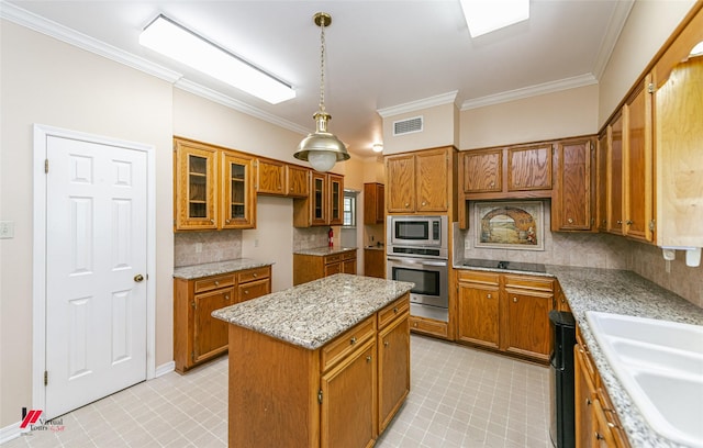 9855 Holamy Ln, Shreveport, LA 71106 - kitchen featuring stainless steel appliances, brown cabinetry, ornamental molding, a kitchen island, and backsplash
