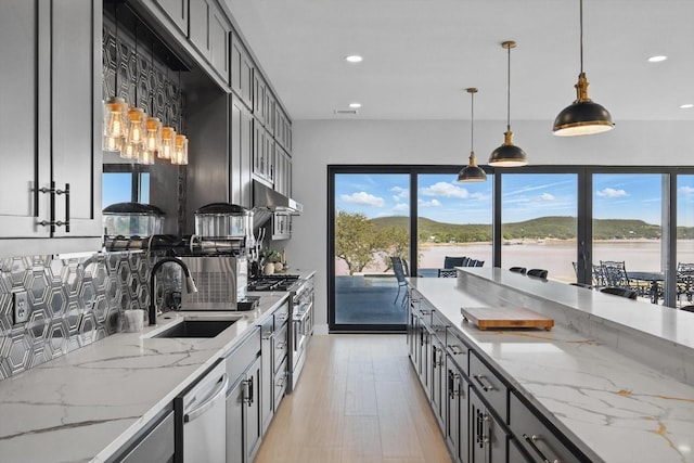 4971 Hawk Rd, Possum Kingdom Lake, TX 76450 - kitchen with a sink, stainless steel appliances, recessed lighting, healthy amount of natural light, and decorative light fixtures