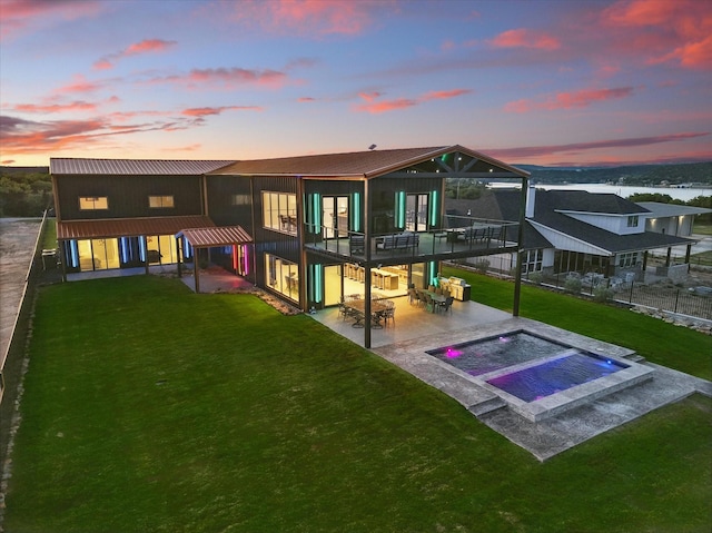 4971 Hawk Rd, Possum Kingdom Lake, TX 76450 - back of property with a patio, an in-ground hot tub, a yard, and metal roof