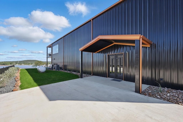 4971 Hawk Rd, Possum Kingdom Lake, TX 76450 - doorway to property featuring a water view, a patio, a yard, board and batten siding, and central AC