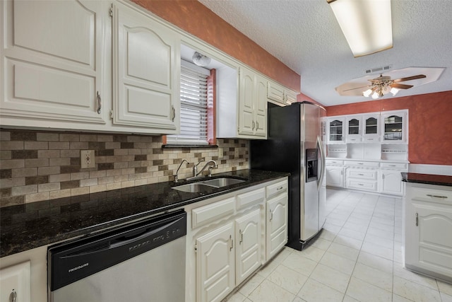1111 Lupine Dr, Garland, TX 75043 - kitchen with stainless steel appliances, a sink, ceiling fan, tasteful backsplash, and a textured ceiling