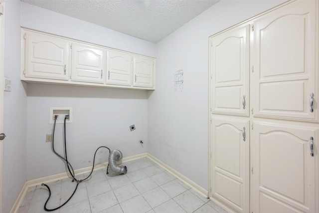 1111 Lupine Dr, Garland, TX 75043 - laundry room featuring cabinet space, hookup for an electric dryer, hookup for a washing machine, a textured ceiling, and baseboards