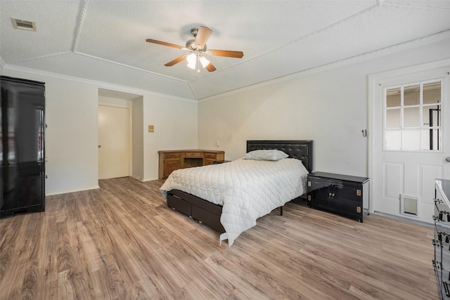 1111 Lupine Dr, Garland, TX 75043 - bedroom featuring light wood finished floors, ornamental molding, baseboards, a ceiling fan, and a textured ceiling