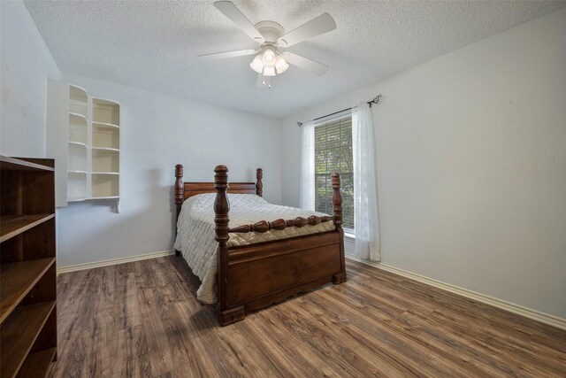 1111 Lupine Dr, Garland, TX 75043 - bedroom with wood finished floors, a textured ceiling, a ceiling fan, and baseboards