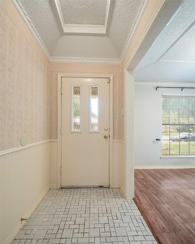1111 Lupine Dr, Garland, TX 75043 - foyer with a textured ceiling, wainscoting, brick patterned flooring, baseboards, and ornamental molding