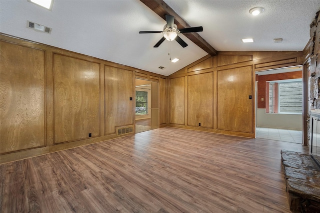 1111 Lupine Dr, Garland, TX 75043 - spare room with wood walls, a ceiling fan, and wood finished floors
