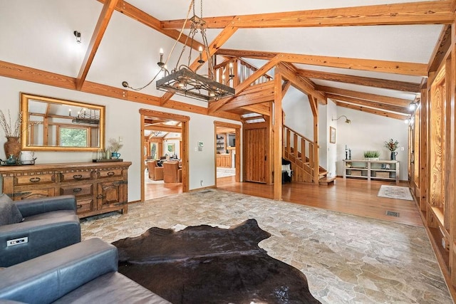 831 Old Justin Rd, Argyle, TX 76226 - living room with stairs, stone flooring, beamed ceiling, a chandelier, and high vaulted ceiling