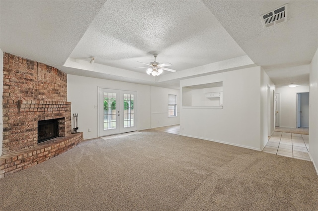 4111 Cypress Springs Dr, Arlington, TX 76001 - unfurnished living room featuring a raised ceiling, light colored carpet, a textured ceiling, ceiling fan, and a brick fireplace