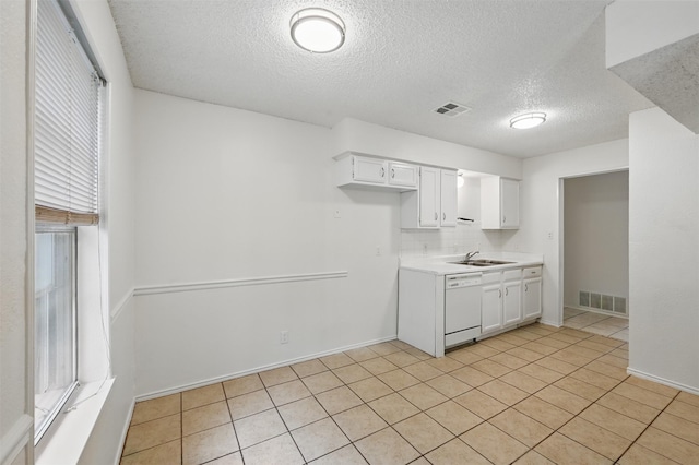 4111 Cypress Springs Dr, Arlington, TX 76001 - kitchen with dishwasher, a textured ceiling, light countertops, white cabinetry, and light tile patterned flooring