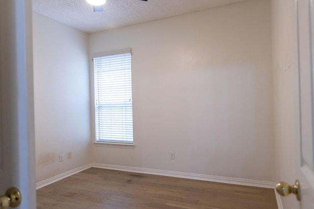 2104 Hunter Place Ln, Arlington, TX 76006 - unfurnished room with wood finished floors, a textured ceiling, a ceiling fan, and baseboards