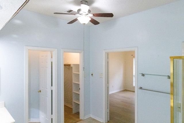 2104 Hunter Place Ln, Arlington, TX 76006 - unfurnished bedroom with a spacious closet, wood finished floors, a closet, ceiling fan, and baseboards