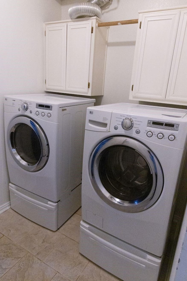 2104 Hunter Place Ln, Arlington, TX 76006 - clothes washing area featuring washing machine and dryer and cabinet space
