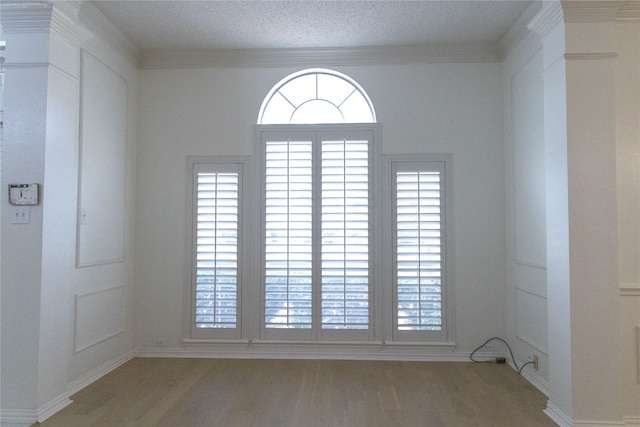 2104 Hunter Place Ln, Arlington, TX 76006 - spare room with wood finished floors, healthy amount of natural light, baseboards, and a textured ceiling