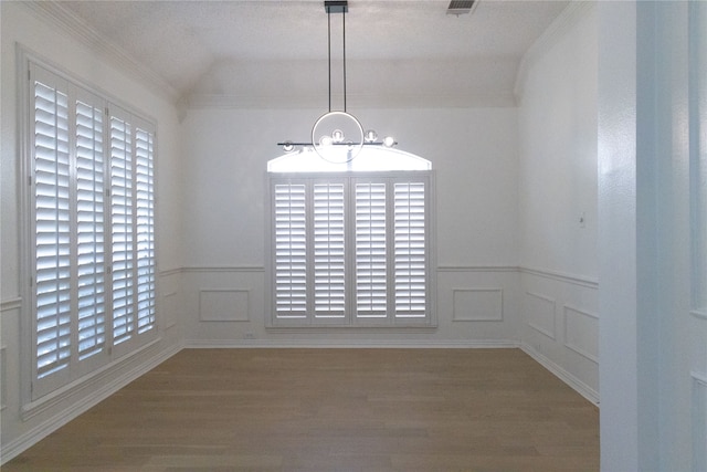 2104 Hunter Place Ln, Arlington, TX 76006 - unfurnished dining area with wood finished floors, a chandelier, wainscoting, a decorative wall, and ornamental molding