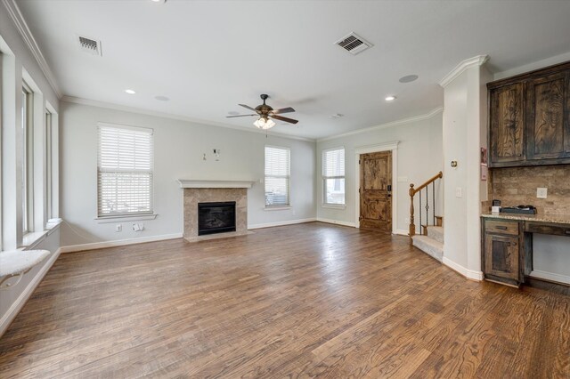 320 Collins St, Argyle, TX 76226 - unfurnished living room with ceiling fan, ornamental molding, a tiled fireplace, stairs, and dark wood finished floors