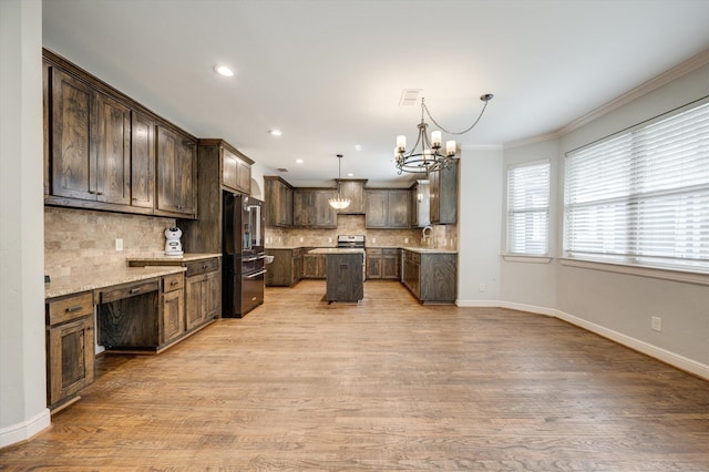 320 Collins St, Argyle, TX 76226 - kitchen with high quality fridge, a chandelier, a center island, decorative backsplash, and dark brown cabinetry